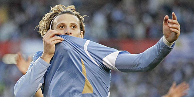 Diego Forln se besa el escudo de su pas. | Reuters
