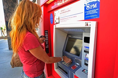 Una mujer usa un cajero automtico de Bank of America. | AFP