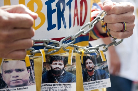 Un hombre protesta en una manifestacin en Bogot con imgenes de secuestrados.| Afp