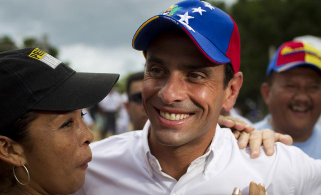 Henrique Capriles con una votante.| Reuters