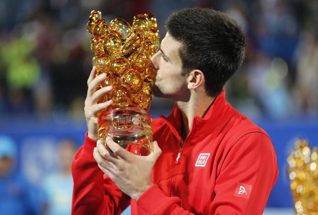 Novak Djokovic besa el trofeo de campen del torneo de Abu Dhabi.