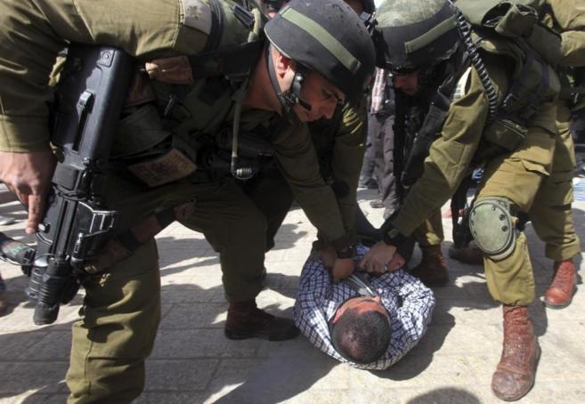 Policas israeles detienen a un manifestante palestino durante un...