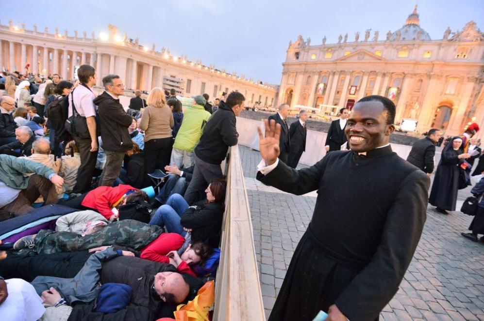 Un sacerdote saluda a un grupo de peregrinos que se despiertan tras...