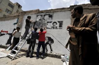 Activistas pintan un mural contra los extranjeros.