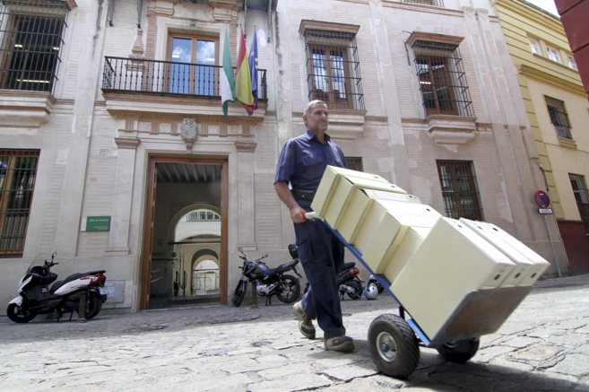 Un funcionario saca cajas de expedientes de la sede de la Direccin...