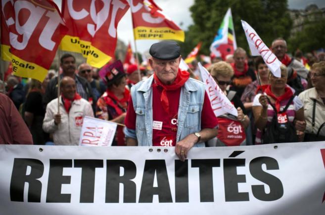 Un jubilado sostine una pancarta durante una marcha en París.