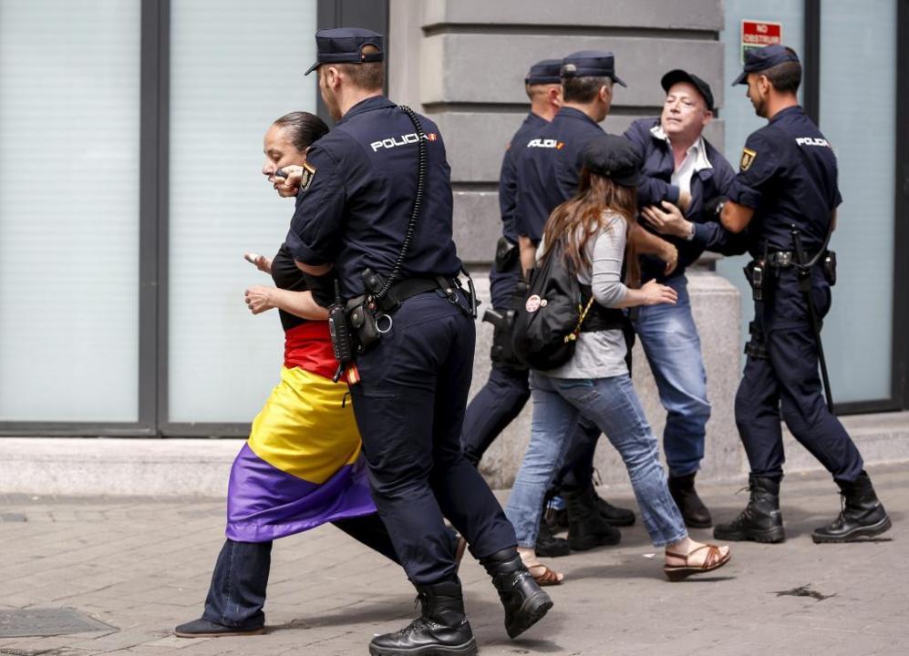 Unos policas tratan de disolver la manifestacin.