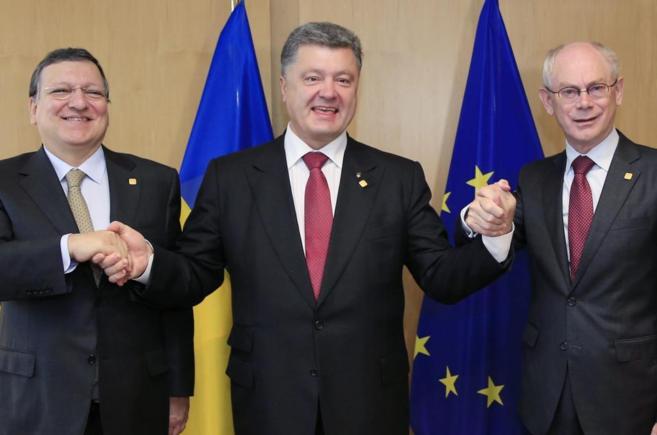 El presidente ucraniano, Poroshenko (centro), junto a Barroso (izda.)...