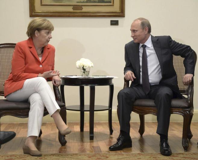 La canciller alemana, Angela Merkel, conversa con el presidente ruso,...