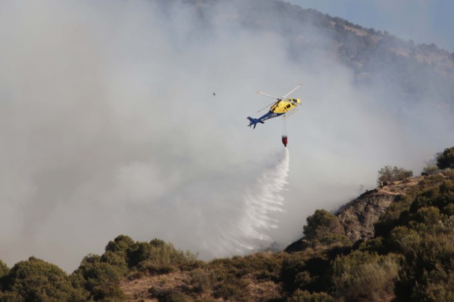 Un helicptero, en plenas labores de extincin del incendio de Cenes...