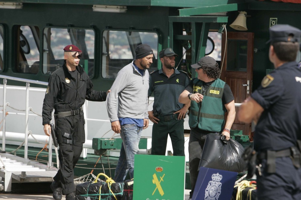 Los agentes en el puerto de Vigo, con uno de los tres detenidos.