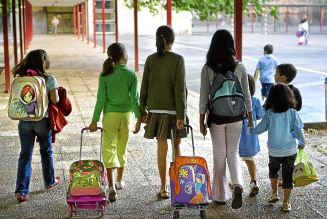 Un grupo de niños van hacia el colegio.