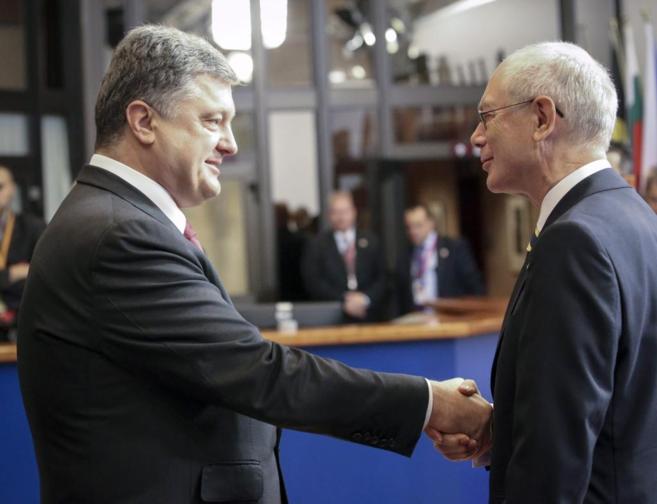 Herman Van Rompuy (dcha.) junto a Petro Poroshenko (izda.) en una...
