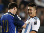 Argentina's Lionel Messi signs an autograph for a fan who invaded...