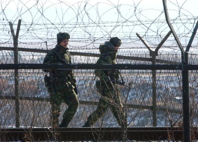 Soldados surcoreanos patrullan junto a la frontera entre las dos...