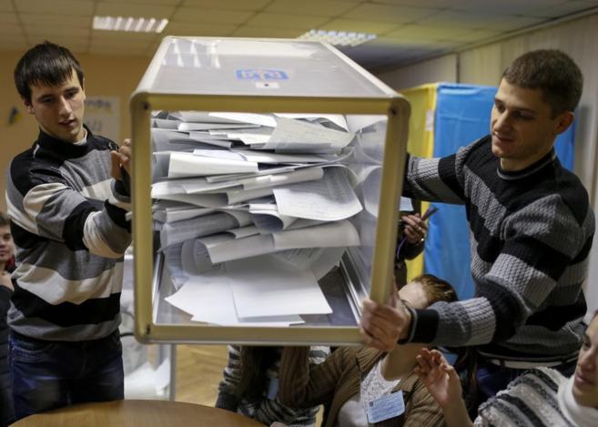 Miembros de la comisin electoral vacan una urna en un colegio en...