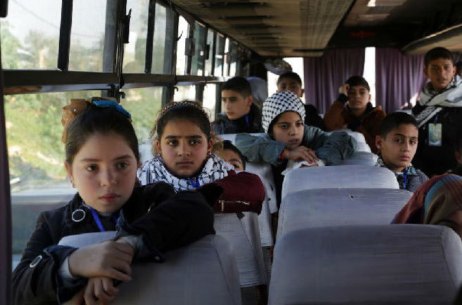 El grupo de nios palestinos, en un autobs en el paso de Erez antes...
