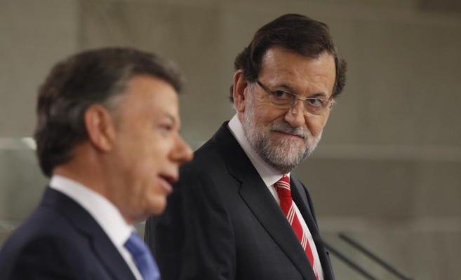 Mariano Rajoy observa al presidente de Colombia durante su...