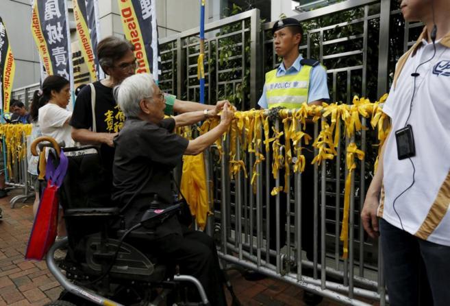 Un hombre coloca lazos amarillos en Hong Kong en vsperas del...