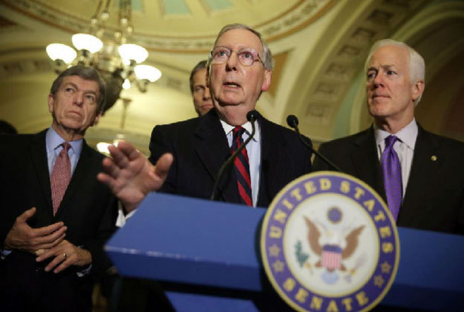 Mitch McConnell and other members of the Republican party address the...