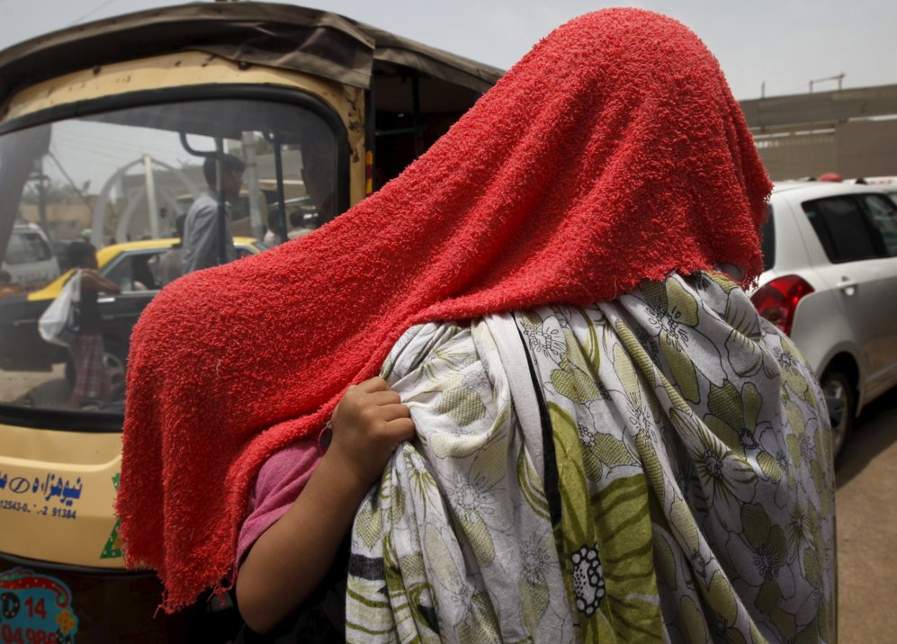 Una madre y su hija se protegen del calor con una toalla mojada en una...