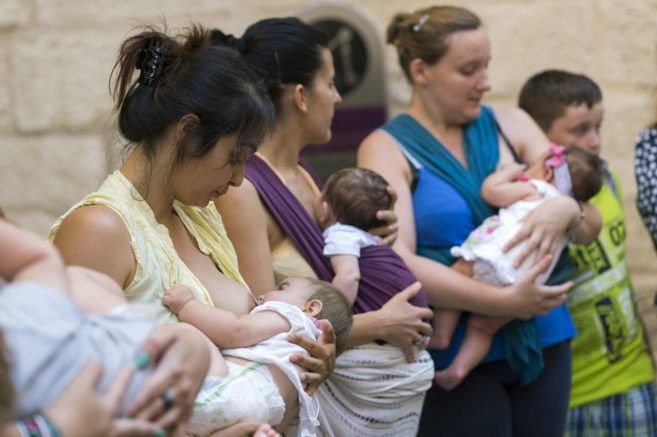 Varias madres dan el pecho a sus hijos ante el Museo Picasso en señal...