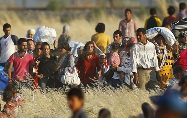 Refugiados de Kobane caminan hacia la frontera con Turqua.