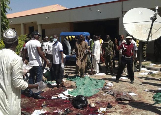 Agentes de seguridad nigerianos inspeccionan la zona del atentado del...