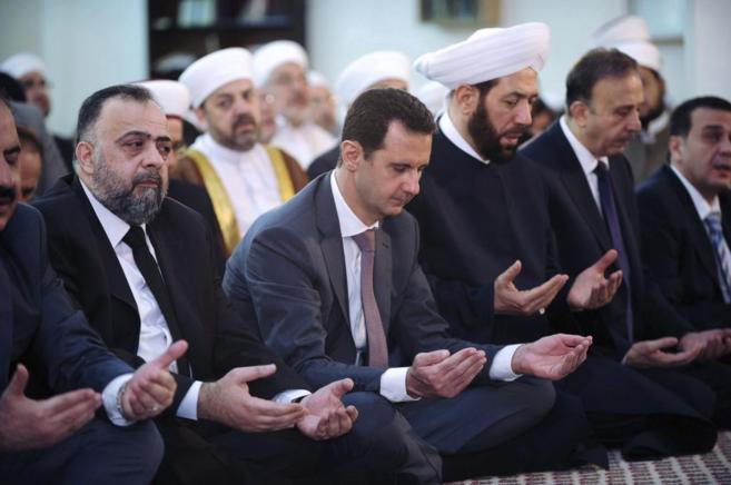 El presidente Bashar Asad reza junto a dignatarios religiosos y del...