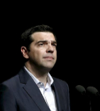 Greek Prime Minister Alexis Tsipras looks on during his speech at the...