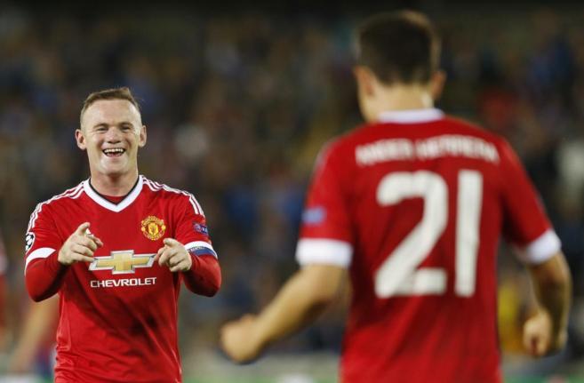 Rooney sonre ante su compaero Ander Herrera.