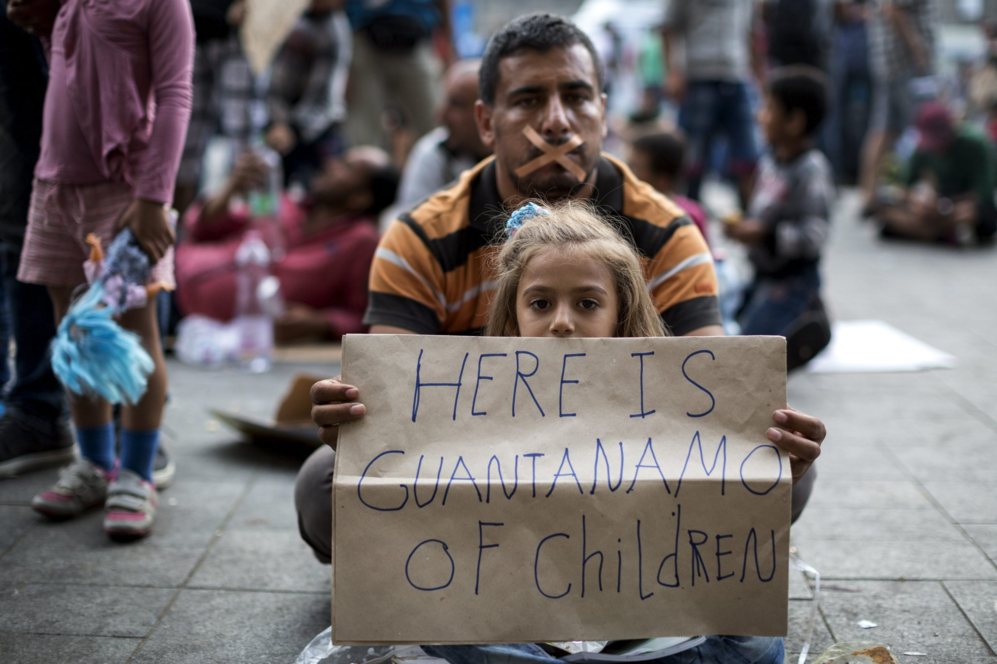 Un padre y su hija protestan con una pancarta en la plaza de la...