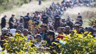 Una multitud de refugiados camina en la frontera entre Croacia y...