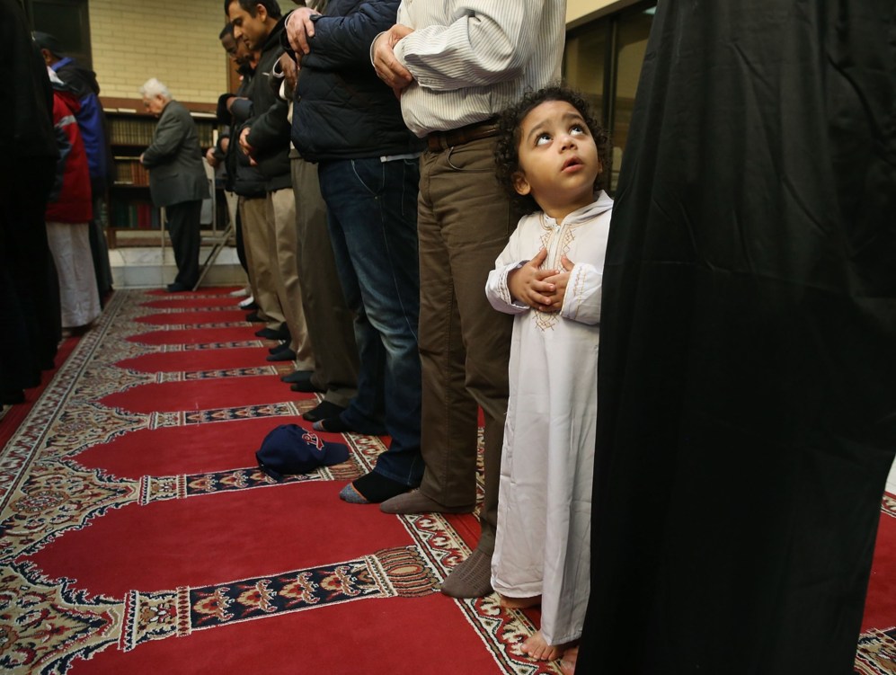 Un nio mira a su padre mientras rezan en una mezquita de Virginia,...