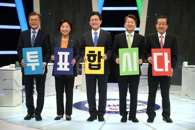 Los candidatos a la presidencia de Corea del Sur sujetan letras que forman la frase: 'Vayamos a votar'.