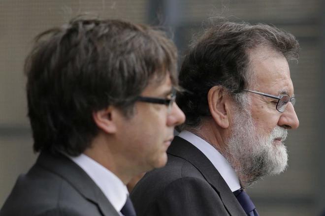 Carles Puigdemont y Mariano Rajoy, en la misa celebrada el domingo en...