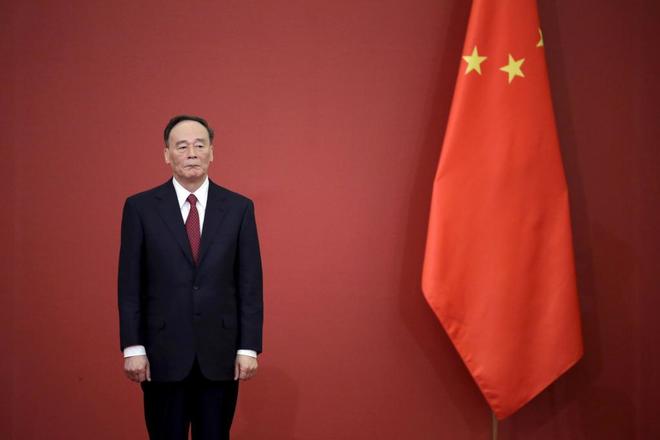 El llamado 'Zar anticorrupcin' de China, Wang Qishan, posa junto a una bandera china en el Gran Saln del Pueblo, en Pekn.