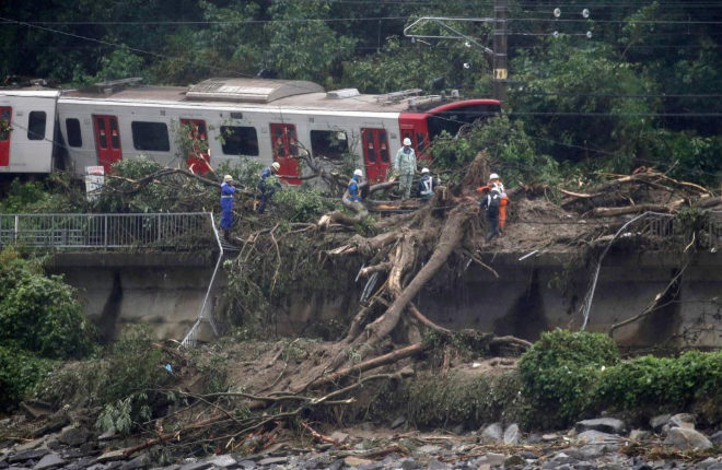 KMA01. Karatsu (Japan), 07/07/2018.- JR railway train is derailed due to heavy rain in Karatsu, Saga Prefecture, southwestern Japan, 07 July 2018. Heavy rainfall killed at least 15 people and left more than 45 missing, public television reported on 07 July 2018. Japan Meteorological Agency has warned record rainfall on 06 July for flooding, mudslides in southwestern and western Japan through 08 July and issued emergency weather warnings to six prefectures. In nine prefectures in western and southwestern Japan, authorities issued evacuation orders to more than one million people as Typhoon Maria passes the area. (Japn) EFE/EPA/JIJI PRESS JAPAN OUT EDITORIAL USE ONLY NO ARCHIVES
