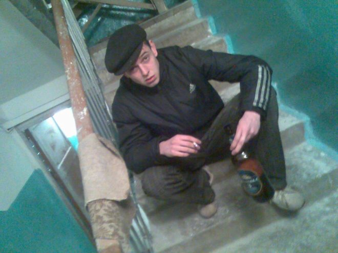 Un joven de esttica Gopnik en las escaleras de un edificio...