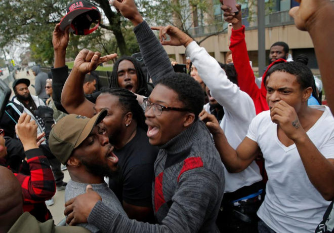 People celebrate the announcement of the guilty verdict in the murder trial of Chicago police officer Jason Van Dyke outside the Leighton Criminal Court Building in Chicago, October 5, 2018. - A white Chicago police officer was found guilty of murder for fatally shooting a black teen, in a politically fraught case that left the city bracing for its outcome. (Photo by JIM YOUNG / AFP)