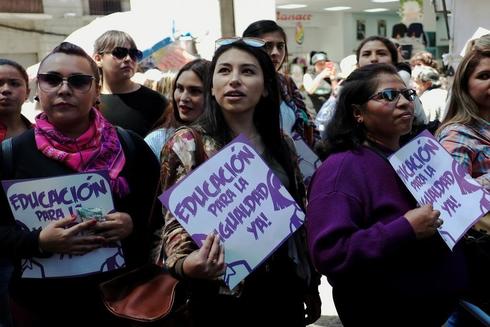 Women participate in a rally during the Women&apos;s Day celebration in La...