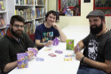 Domingo Cabrero, Santi Santiesteban y  C. Lopez, creadores del juego de cartas "Virus" posan en la tienda de comics y juegos Generacion X de Rivas-Vaciamadrid.