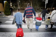 Un padre de Alicante lleva a sus hijos al colegio.