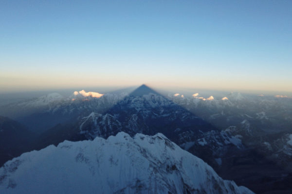Shadow of <HIT>Everest</HIT> is cast on the mountains during the...