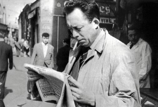 Albert Camus leyendo un peridico en una calle dePars en 1959.