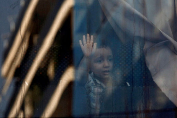 Athens (<HIT>Greece</HIT>).- A refugee boy looks on behind a bus...