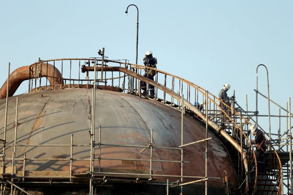 FILE PHOTO: Workers are seen at the damaged site of <HIT>Saudi</HIT>...