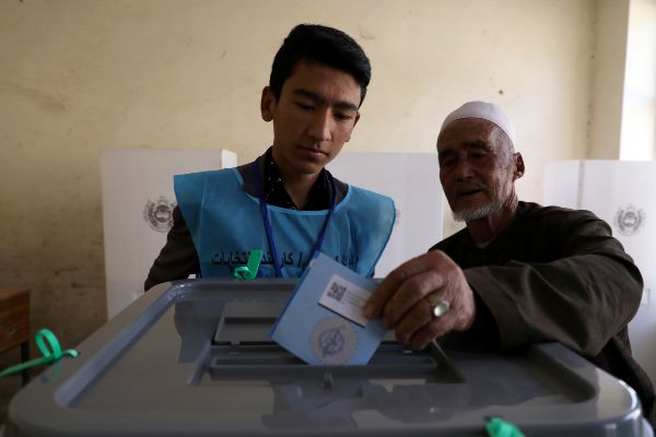 An Afghan man casts his vote at a polling station in Kabul