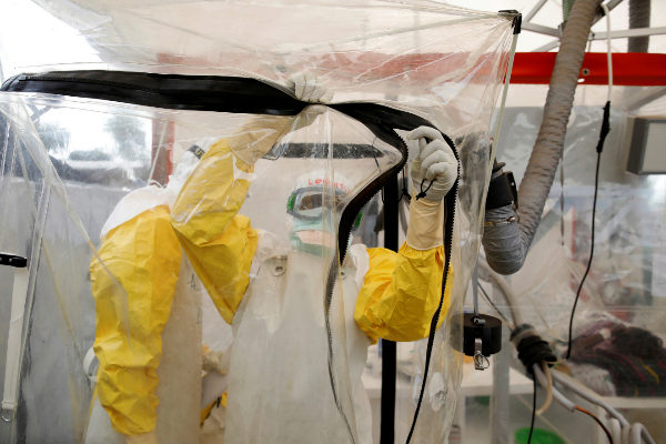 A health worker wearing <HIT>Ebola</HIT> protection gear enters the...