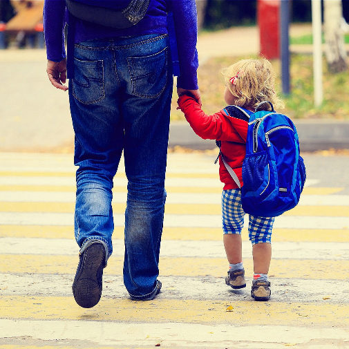 Un progenitor lleva al colegio a su hijo.